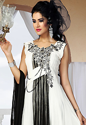 Attract all attentions with this embroidered suit. The dazzling white and black net readymade churidar suit have amazing embroidery patch work is done with zari, stone and cutdana work. The entire ensemble makes an excellent wear. Matching black santoon churidar and black net dupatta is available with this suit. Slight Color variations are possible due to differing screen and photograph resolutions.