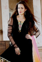 The glamorous silhouette to meet your most dire fashion needs. The dazzling black net anarkali churidar suit have amazing embroidery patch work is done with resham, zari, sequins, beads and lace work. Beautiful embroidery work on kameez is stunning. The entire ensemble makes an excellent wear. Matching churidar and shaded dupatta is available with this suit. Slight Color variations are possible due to differing screen and photograph resolutions.