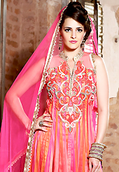 Outfit is a novel ways of getting yourself noticed. The dazzling shaded pink and orange net anarkali churidar suit have amazing embroidery patch work is done with resham, zari, sequins, stone, beads and lace work. Beautiful embroidery work on kameez is stunning. The entire ensemble makes an excellent wear. Matching pink churidar and pink dupatta is available with this suit. Slight Color variations are possible due to differing screen and photograph resolutions.
