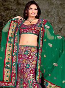 Take a look on the changing fashion of the season. This maroon and green lehenga choli is nicely floral, paisley print, embroidered and patch work done with  resham, sequins and stone work in form of floral motifs. All over embroidery work on lehenga is stunning. The beautiful embroidery on lehenga made it awesome and gives you stylish and attractive look to others. Matching and dupatta is availble with this lehenga. Slight Color variations are possible due to differing screen and photograph resolutions.