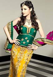 Elegance and innovation of designs crafted for you. This dark yellow and deep green net lehenga choli is nicely embroidered patch work done with resham, zari, stone and beads work in form of floral and paisley motifs. The beautiful embroidery on lehenga made it awesome and gives you stylish and attractive look to others. Contrasting deep green choli and dark pink net dupatta is availble with this lehenga. Choli can be customized upto 42 inches. Slight Color variations are possible due to differing screen and photograph resolutions.