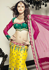Take a look on the changing fashion of the season. This yellow net lehenga choli is nicely embroidered patch work done with resham, zari, stone and beads work in form of floral motifs. The beautiful embroidery on lehenga made it awesome and gives you stylish and attractive look to others. Contrasting dark green choli and dark pink dupatta is availble with this lehenga. Choli can be customized upto 42 inches. Slight Color variations are possible due to differing screen and photograph resolutions.
