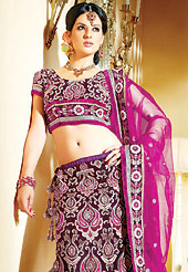 Get ready to sizzle all around you by sparkling lehenga. This dark burgundy net A-Line lehenga choli is nicely embroidered and velvet patch border is done with resham, zari and stone work. The beautiful embroidery on lehenga made it awesome and gives you stylish and attractive look to others. Matching net choli and magenta net dupatta is availble with this lehenga. Slight Color variations are possible due to differing screen and photograph resolutions.