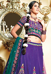 Embroidered lehengas are highly in order on a range of occasions such as wedding, formal party and festivals. This dark purple net lehenga choli is nicely embroidered and velvet patch border is done with zari, sequins and stone work. The beautiful embroidery on lehenga made it awesome and gives you stylish and attractive look to others. Matching net choli and contrasting teal green net dupatta is availble with this lehenga. Slight Color variations are possible due to differing screen and photograph resolutions.