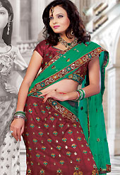 The evolution of style species collection spells pure femininity.  This red net lehenga choli is nicely embroidered and patch work done with resham and sequins work in form of floral motifs. The beautiful embroidery on lehenga made it awesome and gives you stylish and attractive look to others. Matching choli and green dupatta is availble with this lehenga. Slight Color variations are possible due to differing screen and photograph resolutions.