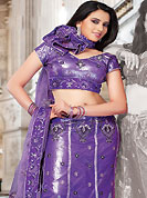 Outfit is a novel ways of getting yourself noticed. This dark purple net and shimmer lehenga choli is nicely embroidered and patch work done with resham and sequins work. The beautiful embroidery on lehenga made it awesome and gives you stylish and attractive look to others. Matching choli and dupatta is availble with this lehenga. Slight Color variations are possible due to differing screen and photograph resolutions.