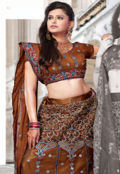 Let your personality speak for you this bridal lehenga embellished with embroidery work. This dark brown net lehenga choli is nicely embroidered and patch work done with resham and sequins work. The beautiful embroidery on lehenga made it awesome and gives you stylish and attractive look to others. Matching choli and dupatta is availble with this lehenga. Slight Color variations are possible due to differing screen and photograph resolutions.