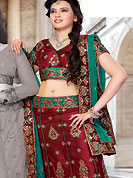 Elegance and innovation of designs crafted for you. This maroon net lehenga choli is nicely embroidered and patch work done with resham and sequins work. The beautiful embroidery on lehenga made it awesome and gives you stylish and attractive look to others. Matching choli and contrasting teal green net dupatta is availble with this lehenga. Slight Color variations are possible due to differing screen and photograph resolutions.