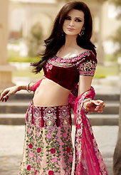Embroidered lehengas are highly in order on a range of occasions such as wedding, formal party and festivals. This light pink lehenga choli is nicely embroidered and patch work done with resham, zari, sequins and stone work in form of floral motifs. The beautiful embroidery on lehenga made it awesome and gives you stylish and attractive look to others. Contrasting maroon embroidery work choli and dark pink net dupatta is availble with this lehenga. Slight Color variations are possible due to differing screen and photograph resolutions.