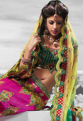 Embroidered lehengas are highly in order on a range of occasions such as wedding, formal party and festivals. This dark pink raw silk lehenga is nicely embroidered patch work is done with resham, zari, sequins, stone and kundan work. The beautiful embroidery on lehenga made it awesome and gives you stylish and attractive look to others. Contrasting green choli and shaded yellow and sea green net dupatta is availble with this lehenga. Slight Color variations are possible due to differing screen and photograph resolutions.