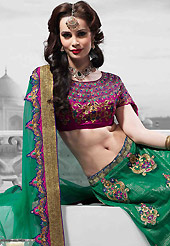 The evolution of style species collection spells pure femininity. This green net lehenga is nicely embroidered patch work is done with resham, zari, stone, kundan and lace work. The beautiful embroidery on lehenga made it awesome and gives you stylish and attractive look to others. Contrasting dark pink art silk choli and green net dupatta is availble with this lehenga. Slight Color variations are possible due to differing screen and photograph resolutions.