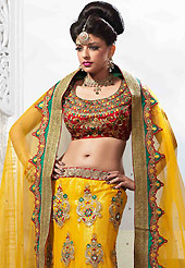 Get ready to sizzle all around you by sparkling lehenga. This yellow net lehenga is nicely embroidered patch work is done with resham, zari, stone, kundan and lace work. The beautiful embroidery on lehenga made it awesome and gives you stylish and attractive look to others. Contrasting red art silk choli and yellow net dupatta is availble with this lehenga. Slight Color variations are possible due to differing screen and photograph resolutions.