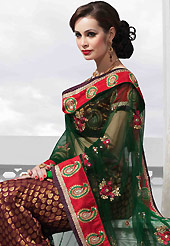 Make your collection more attractive and charming with this impressive dress. This maroon art silk lehenga is nicely embroidered patch work is done with resham, zari, sequins, stone and lace work. The beautiful embroidery on lehenga made it awesome and gives you stylish and attractive look to others. Matching choli and dark green net dupatta is availble with this lehenga. Slight Color variations are possible due to differing screen and photograph resolutions.