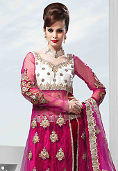 Dreamy variation on shape and forms compliment your style with tradition. This dark magenta velvet lehenga is nicely embroidered patch work is done with resham, zari, sequins, stone, cutdana, kundan and lace work. The beautiful embroidery on lehenga made it awesome and gives you stylish and attractive look to others. Designer net long choli with off white color raw silk yoke part and matching net dupatta is availble with this lehenga. Slight Color variations are possible due to differing screen and photograph resolutions.