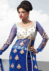 Elegance and innovation of designs crafted for you. This blue velvet lehenga is nicely embroidered patch work is done with resham, zari, sequins, stone, cutdana, kundan and lace work. The beautiful embroidery on lehenga made it awesome and gives you stylish and attractive look to others. Designer net long choli with off white color raw silk yoke part and matching net dupatta is availble with this lehenga. Slight Color variations are possible due to differing screen and photograph resolutions.
