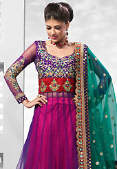 Embroidered lehengas are highly in order on a range of occasions such as wedding, formal party and festivals. This red and purple net lehenga is nicely embroidered patch work is done with resham, zari, sequins, stone, kundana and lace work. The beautiful embroidery on lehenga made it awesome and gives you stylish and attractive look to others. Amazing purple color net long choli with fabulous work yoke part and teal green net dupatta is availble with this lehenga. Slight Color variations are possible due to differing screen and photograph resolutions.