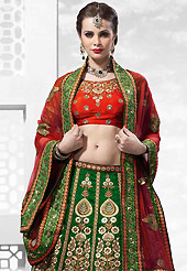 Get ready to sizzle all around you by sparkling lehenga. This dark green and red raw silk lehenga is nicely embroidered patch work is done with resham, zari, sequins, stone, kasab, beads and lace work. The beautiful embroidery on lehenga made it awesome and gives you stylish and attractive look to others. Contrasting red art silk choli and red net dupatta is availble with this lehenga. Slight Color variations are possible due to differing screen and photograph resolutions.