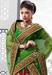 It’s cool and has a very modern look to impress all. This red and green raw silk lehenga is nicely embroidered patch work is done with resham, zari, sequins, stone, kasab, beads and lace work. The beautiful embroidery on lehenga made it awesome and gives you stylish and attractive look to others. Contrasting green art silk choli and green net dupatta is availble with this lehenga. Slight Color variations are possible due to differing screen and photograph resolutions.