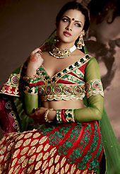 Get ready to sizzle all around you by sparkling lehenga. This maroon net lehenga is nicely embroidered patch work is done with resham, zari, sequins, stone and lace work. The beautiful embroidery on lehenga made it awesome and gives you stylish and attractive look to others. Contrasting red and green choli and green net dupatta is availble with this lehenga. Slight Color variations are possible due to differing screen and photograph resolutions.