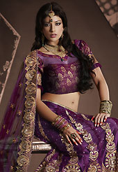 Take a look on the changing fashion of the season. This dark purple net lehenga is nicely embroidered patch work is done with resham, zari, sequins, stone and lace work. The beautiful embroidery on lehenga made it awesome and gives you stylish and attractive look to others. Matching choli and dupatta is availble with this lehenga. Slight Color variations are possible due to differing screen and photograph resolutions.