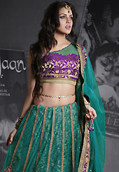 Outfit is a novel ways of getting yourself noticed. This teal green net lehenga is nicely embroidered patch work is done with resham, zari, sequins, stone and lace work. The beautiful embroidery on lehenga made it awesome and gives you stylish and attractive look to others. Contrasting purple choli and teal green net dupatta is availble with this lehenga. Slight Color variations are possible due to differing screen and photograph resolutions.