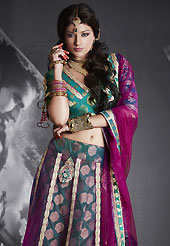 Make your collection more attractive and charming with this impressive dress. This purple and teal green net and viscose lehenga is nicely embroidered patch work is done with resham, zari, sequins, stone and lace work. The beautiful embroidery on lehenga made it awesome and gives you stylish and attractive look to others. Matching teal green choli and purple net dupatta is availble with this lehenga. Slight Color variations are possible due to differing screen and photograph resolutions.
