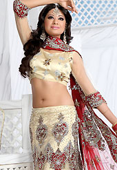 Make your collection more attractive and charming with this impressive dress. This cream net lehenga is nicely embroidered and velvet patch work is done with stone, zardosi, cutdana and cutbeads work. The beautiful embroidery on lehenga made it awesome and gives you stylish and attractive look to others. Matching choli and red net dupatta is availble with this lehenga. Slight Color variations are possible due to differing screen and photograph resolutions.