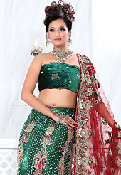 Take a look on the changing fashion of the season. This dark green net lehenga is nicely embroidered and velvet patch work is done with stone, zardosi, cutdana and cutbeads work. The beautiful embroidery on lehenga made it awesome and gives you stylish and attractive look to others. Matching choli and dark red net dupatta is availble with this lehenga. Slight Color variations are possible due to differing screen and photograph resolutions.