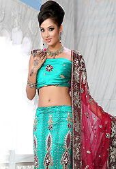 Bold colors created by the inventive drapes of textile catch the imagination like no other contemporary clothing. This turquoise blue net lehenga is nicely embroidered and velvet patch work is done with stone, zardosi, cutdana and cutbeads work. The beautiful embroidery on lehenga made it awesome and gives you stylish and attractive look to others. Matching choli and red net dupatta is availble with this lehenga. Slight Color variations are possible due to differing screen and photograph resolutions.