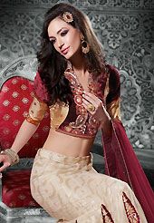 Let your personality speak for you this bridal lehenga embellished with embroidery work. This cream net a-line lehenga choli is nicely embroidered and velvet patch border is done with resham, zari, sequins, stone and lace work. The beautiful embroidery on lehenga made it awesome and gives you stylish and attractive look to others. Contrasting maroon and light gold velvet and shimmer choli and maroon net dupatta is availble with this lehenga. Slight Color variations are possible due to differing screen and photograph resolutions.