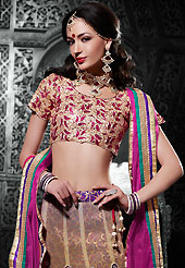 Ultimate collection of embroidered lehengas with fabulous style. This shaded mustard net a-line lehenga choli is nicely embroidered patch border is done with resham, zari, stone and lace work. The beautiful embroidery on lehenga made it awesome and gives you stylish and attractive look to others. Contrasting magenta art silk choli and magenta net dupatta is availble with this lehenga. Slight Color variations are possible due to differing screen and photograph resolutions.