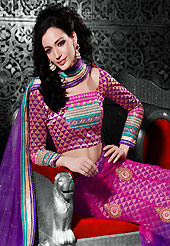 Make your collection more attractive and charming with this impressive dress. This magenta and purple net a-line lehenga choli is nicely embroidered patch border is done with resham, zari, stone and lace work. The beautiful embroidery on lehenga made it awesome and gives you stylish and attractive look to others. Matching magenta and purple brocade choli and purple net dupatta is availble with this lehenga. Slight Color variations are possible due to differing screen and photograph resolutions.