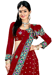 Dreamy variation on shape and forms compliment your style with tradition. This dark red faux georgette lehenga is nicely embroidered patch work is done with resham, zari, sequins and stone work. The beautiful embroidery on lehenga made it awesome and gives you stylish and attractive look to others. Matching choli and dupatta is availble with this lehenga. Slight Color variations are possible due to differing screen and photograph resolutions.