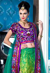 Ultimate collection of embroidered lehengas with fabulous style. This shaded green net a-line lehenga choli is nicely embroidered patch border is done with resham, zari, sequins, stone and lace work. The beautiful embroidery on lehenga made it awesome and gives you stylish and attractive look to others. Contrasting purple choli and turquoise green net dupatta is availble with this lehenga. Slight Color variations are possible due to differing screen and photograph resolutions.