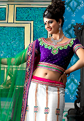 Take the fashion industry by storm in this beautiful embroidered lehengas. This white net a-line lehenga choli is nicely embroidered patch border is done with resham, zari, sequins, stone, beads and lace work. The beautiful embroidery on lehenga made it awesome and gives you stylish and attractive look to others. Contrasting dark purple velvet choli and green net dupatta is availble with this lehenga. Slight Color variations are possible due to differing screen and photograph resolutions.
