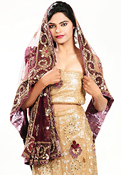 Outfit is a novel ways of getting yourself noticed. This beige brown net lehenga is nicely embroidered and velvet patch work is done with applique, cutdana, stone, beads and cutbeads work. The beautiful embroidery on lehenga made it awesome and gives you stylish and attractive look to others. Matching choli and dark burgundy net dupatta is availble with this lehenga. Slight Color variations are possible due to differing screen and photograph resolutions.