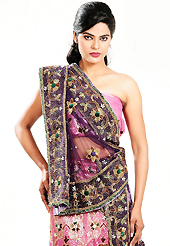 Let your personality speak for you this wedding lehenga embellished with embroidery work. This pink net lehenga is nicely embroidered patch work is done with cutdana, sequins, stone, beads and cutbeads work. The beautiful embroidery on lehenga made it awesome and gives you stylish and attractive look to others. Matching choli and purple net dupatta is availble with this lehenga. Slight Color variations are possible due to differing screen and photograph resolutions.