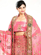Bold colors created by the inventive drapes of textile catch the imagination like no other contemporary clothing. This pink georgette lehenga is nicely embroidered and velvet patch work is done with zardosi, stone, beads and cutbeads work. The beautiful embroidery on lehenga made it awesome and gives you stylish and attractive look to others. Matching choli and dupatta is availble with this lehenga. Slight Color variations are possible due to differing screen and photograph resolutions.