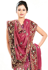 Make your collection more attractive and charming with this impressive dress. This deep pink georgette lehenga is nicely embroidered patch work is done with zardosi, stone, beads and cutbeads work. The beautiful embroidery on lehenga made it awesome and gives you stylish and attractive look to others. Matching choli and dupatta is availble with this lehenga. Slight Color variations are possible due to differing screen and photograph resolutions.