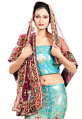 Embroidered lehengas are highly in order on a range of occasions such as wedding, formal party and festivals. This aqua blue net lehenga is nicely embroidered and velvet patch work is done with zardosi, cutdana, stone, beads and cutbeads work. The beautiful embroidery on lehenga made it awesome and gives you stylish and attractive look to others. Matching choli and deep pink net dupatta is availble with this lehenga. Slight Color variations are possible due to differing screen and photograph resolutions.