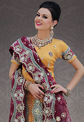 Make your collection more attractive and charming with this impressive dress. This yellow net lehenga choli is nicely embroidery and velvet patch work is done with stone, zardosi, cutdana and cutbeads work. All over embroidery work on lehenga is stunning. The beautiful heavy embroidery on lehenga made it awesome and gives you stylish and attractive look to others. Matching choli and burgundy net dupatta is availble with this lehenga. Slight Color variations are possible due to differing screen and photograph resolutions.