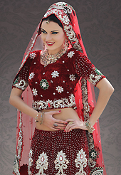 Make your collection more attractive and charming with this impressive dress. This maroon velvet lehenga choli is nicely embroidered patch work is done with stone, zardosi, cutdana and cutbeads work. All over embroidery work on lehenga is stunning. The beautiful heavy embroidery on lehenga made it awesome and gives you stylish and attractive look to others. Matching choli and red net dupatta is availble with this lehenga. Slight Color variations are possible due to differing screen and photograph resolutions.