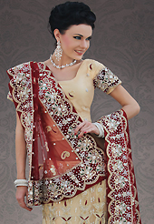 Take a look on the changing fashion of the season. This beige net lehenga choli is nicely embroidery and velvet patch work is done with stone, zardosi, cutdana, beads and cutbeads work. All over embroidery work on lehenga is stunning. The beautiful heavy embroidery on lehenga made it awesome and gives you stylish and attractive look to others. Matching choli and dark red net dupatta is availble with this lehenga. Slight Color variations are possible due to differing screen and photograph resolutions.