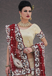 Elegance and innovation of designs crafted for you. This beige net lehenga choli is nicely embroidery and velvet patch work is done with stone, zardosi, cutdana, beads and cutbeads work. All over embroidery work on lehenga is stunning. The beautiful heavy embroidery on lehenga made it awesome and gives you stylish and attractive look to others. Matching choli and maroon net dupatta is availble with this lehenga. Slight Color variations are possible due to differing screen and photograph resolutions.