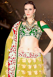 Embroidered lehengas are highly in order on a range of occasions such as wedding, formal party and festivals. This yellow net lehenga choli is nicely embroidered patch work is done with zari, gota patti and lace work. All over embroidery work on lehenga is stunning. The beautiful heavy embroidery on lehenga made it awesome and gives you stylish and attractive look to others. Contrasting green choli and yellow net dupatta is availble with this lehenga. Accessories shown in the image is just for photography purpose. Slight Color variations are possible due to differing screen and photograph resolutions.