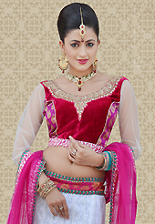 Take a look on the changing fashion of the season. This off white net a-line lehenga is nicely embroidered patch work is done with resham, zari and stone work. The beautiful embroidery on lehenga made it awesome and gives you stylish and attractive look to others. Contrasting red and pink choli and pink net dupatta is availble with this lehenga. Slight Color variations are possible due to differing screen and photograph resolutions.