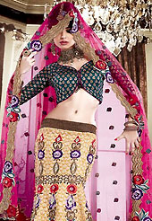 Make your collection more attractive and charming with this impressive dress. This fawn, teal and magenta lehenga choli is nicely floral embroidered patch work. Embroidery is done with resham, zari, sequins, self weaving and beads work in form of floral motifs. The beautiful embroidery lehenga and brocade choli made it awesome and gives you stylish and attractive look to others. Contrasting teal brocade choli and bluemagenta net dupatta is available with this lehenga. Contrasting choli are enhanced your personality. Slight Color variations are possible due to differing screen and photograph resolutions.