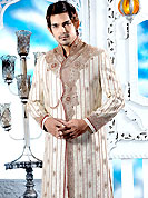 Emblem of fashion and style, each piece of our range of designer sherwani is certain to enhance your look as per todays trends. This off white sherwani embellished with heavy resham, zari, beads, cutdana, stone and patch work. The beautiful heavy embroidery on front border, collar, back and cuffs made it awesome and gives you stylish and attractive look to others. Contrasting churidar is enhanced your personality. This sherwani made with jacquard fabric. Accessories shown in the image is just for photography purpose. Slight Color variations are possible due to differing screen and photograph resolutions.