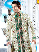 Make your collection more attractive with this dazzling dress. This cream sherwani embellished with green patch, fancy crystal, beads, sequins, stone and pitta work. The beautiful heavy embroidery on front border, collar, back and cuffs made it awesome and gives you stylish and attractive look to others. Contrasting churidar is enhanced your personality. This sherwani made with cotton silk fabric. Accessories shown in the image is just for photography purpose. Slight Color variations are possible due to differing screen and photograph resolutions.