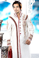 Its cool and have a very modern look to impress all. This off white sherwani embellished with resham, beads, sawroski diamond, zarkan , broches, stone and patch work. The beautiful heavy embroidery on front border, collar, back and cuffs made it awesome and gives you stylish and attractive look to others. Contrasting churidar is enhanced your personality. This sherwani made with jacquard fabric. Accessories shown in the image is just for photography purpose. Slight Color variations are possible due to differing screen and photograph resolutions.